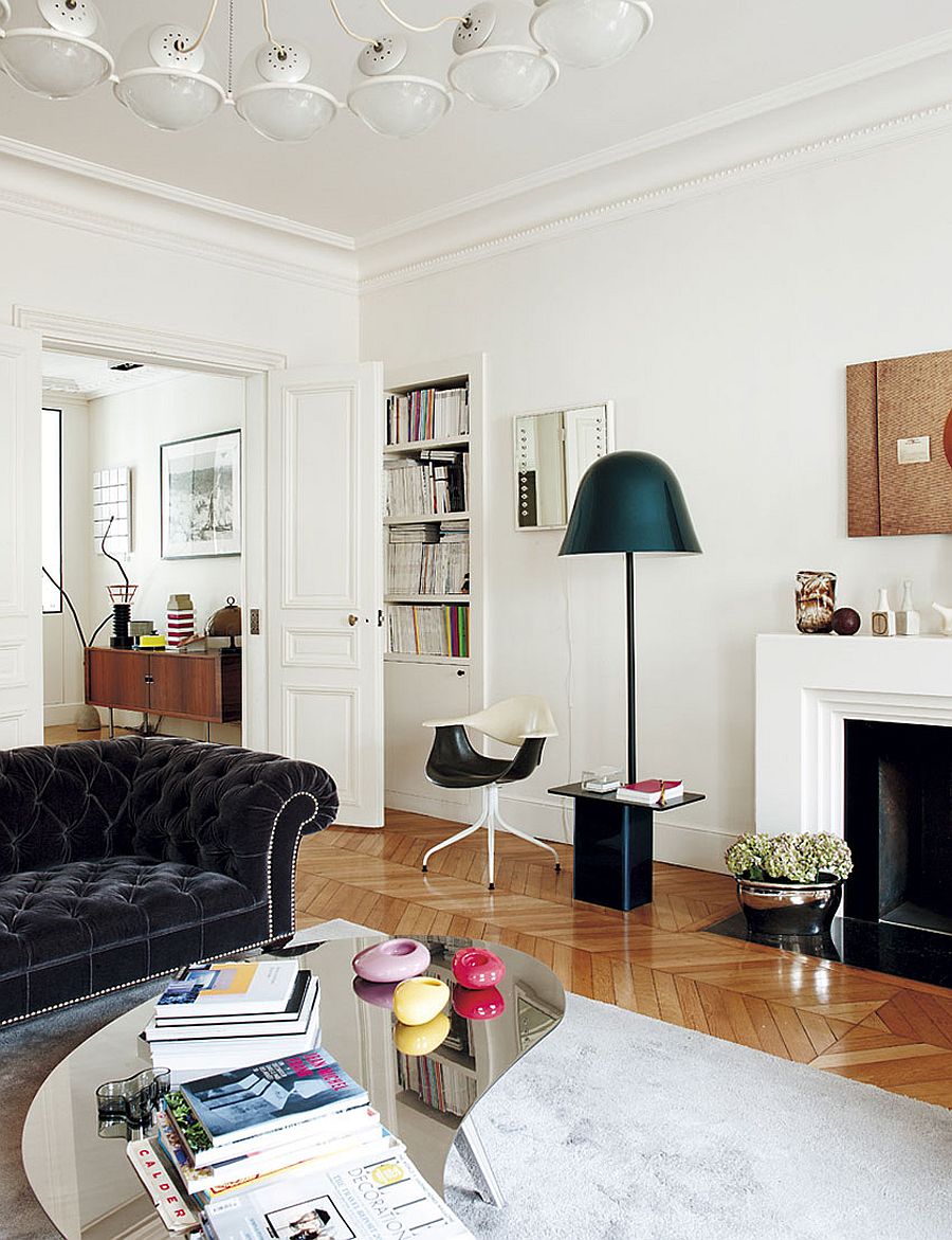 Floor lamp and stylish seating next to the fireplace shape the reading noodk