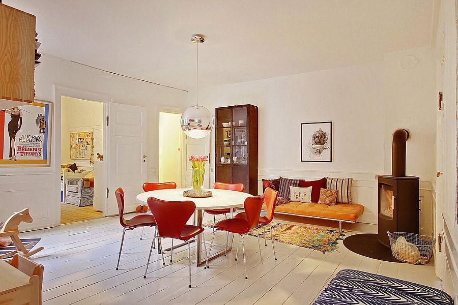 Formal dining space of the Scandinavian apartment with midcentury chairs