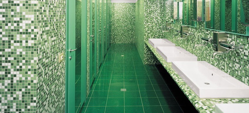 Green terrazzo tile in a commercial bathroom
