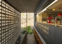 Hollowed-out-concrete-elements-allows-light-to-filter-through-into-the-kitchen-217x155