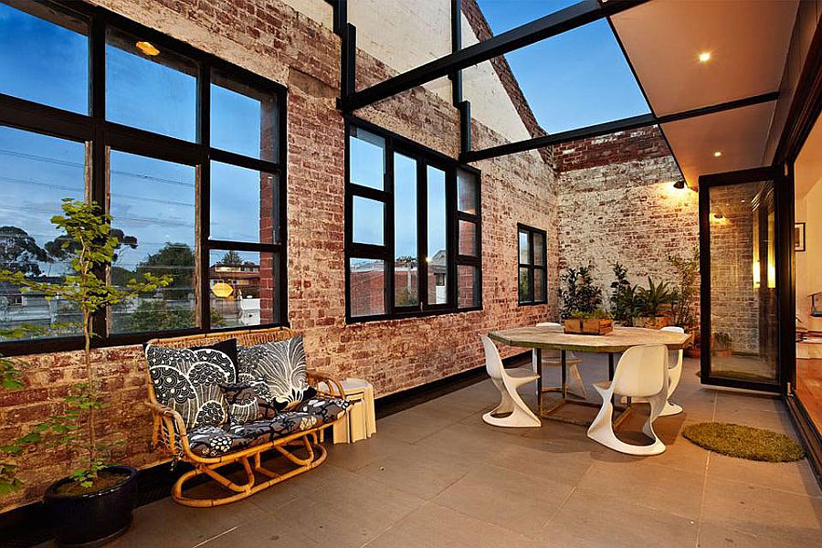 Industrial style courtyard of the Melbourne home with brick walls