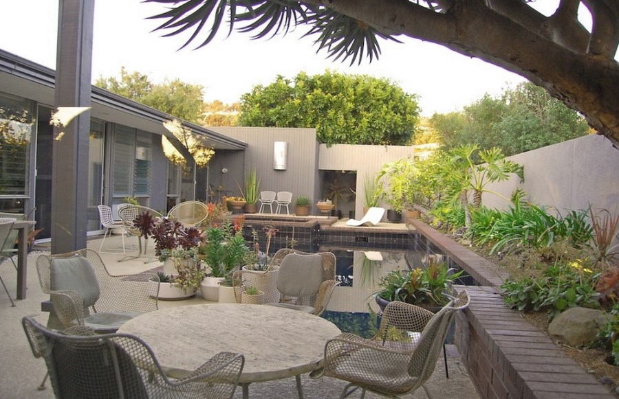 Interesting containers fill this poolside patio
