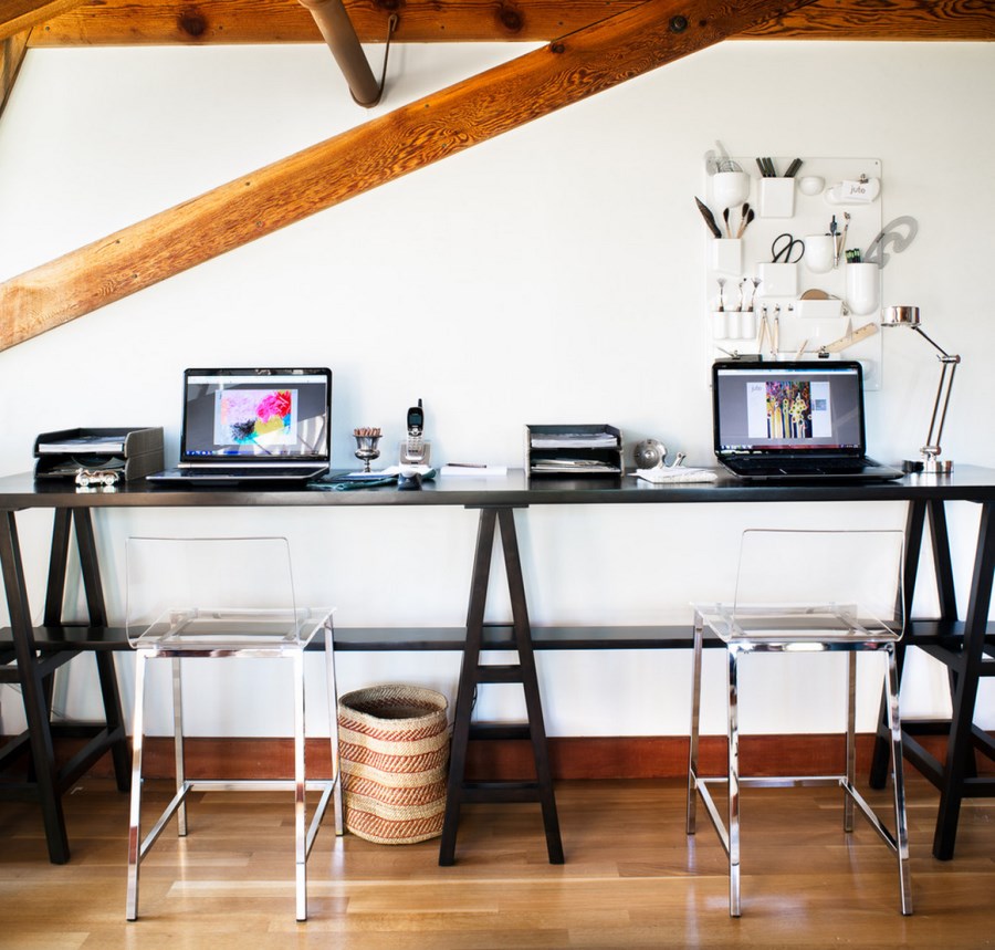 Long dark wooden trestle table desk in a modern home office