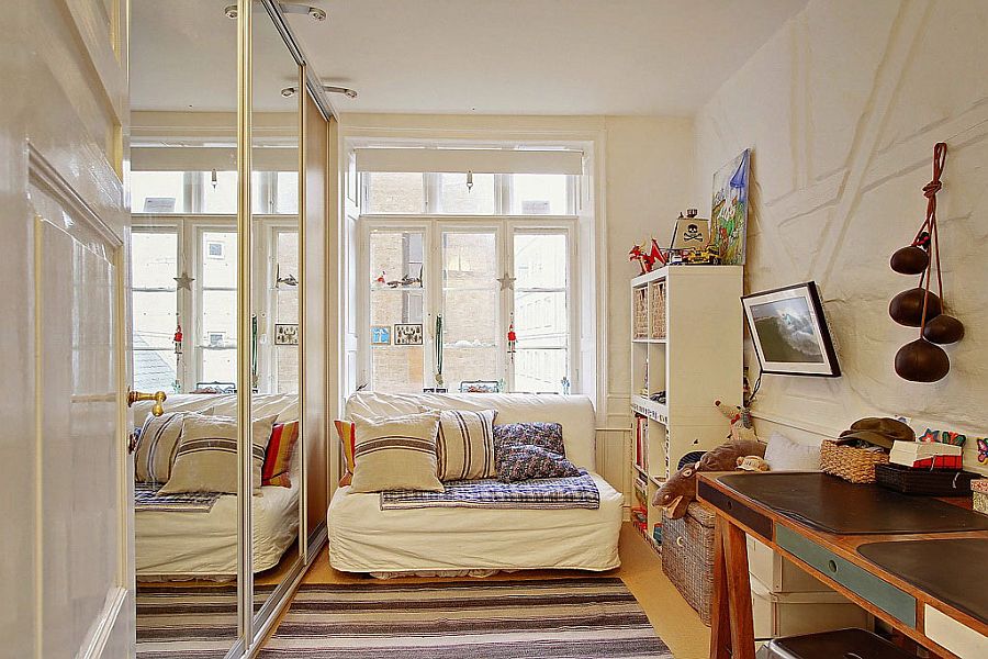 Mirrored cabinets enhnace the visual space inside the small apartment room