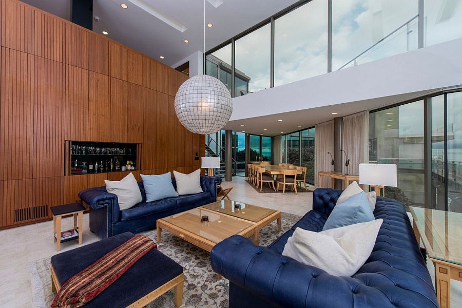 Plush blue couches and gorgeous pendant light in the living room