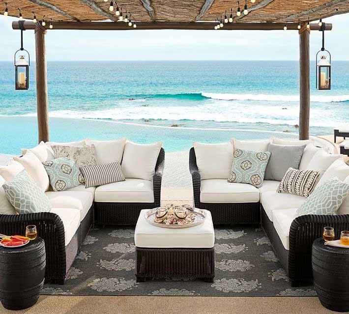 Pottery Barn black wicker sofa near ocean