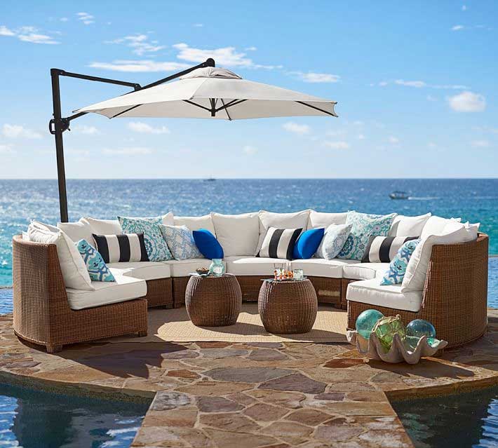 Pottery Barn honey wicker sectional next to ocean