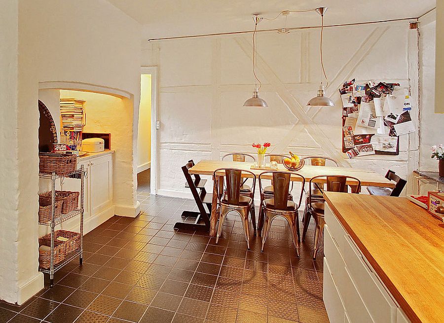 Rough walls in the dining room bring textural contrast to the Scandinavian home