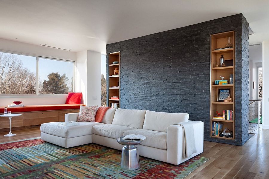 Slate wall with bookshelves acts as the accent addition in the chic Midcentury Modern living room