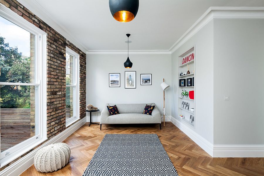 Small living room with brick wall and Tom Dixon pendants