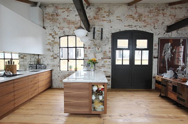 Smart industrial kitchen with a brick wall backdrop [Design: Increation Interior Design]