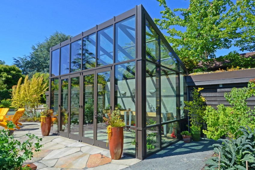 Stone patio near a modern greenhouse