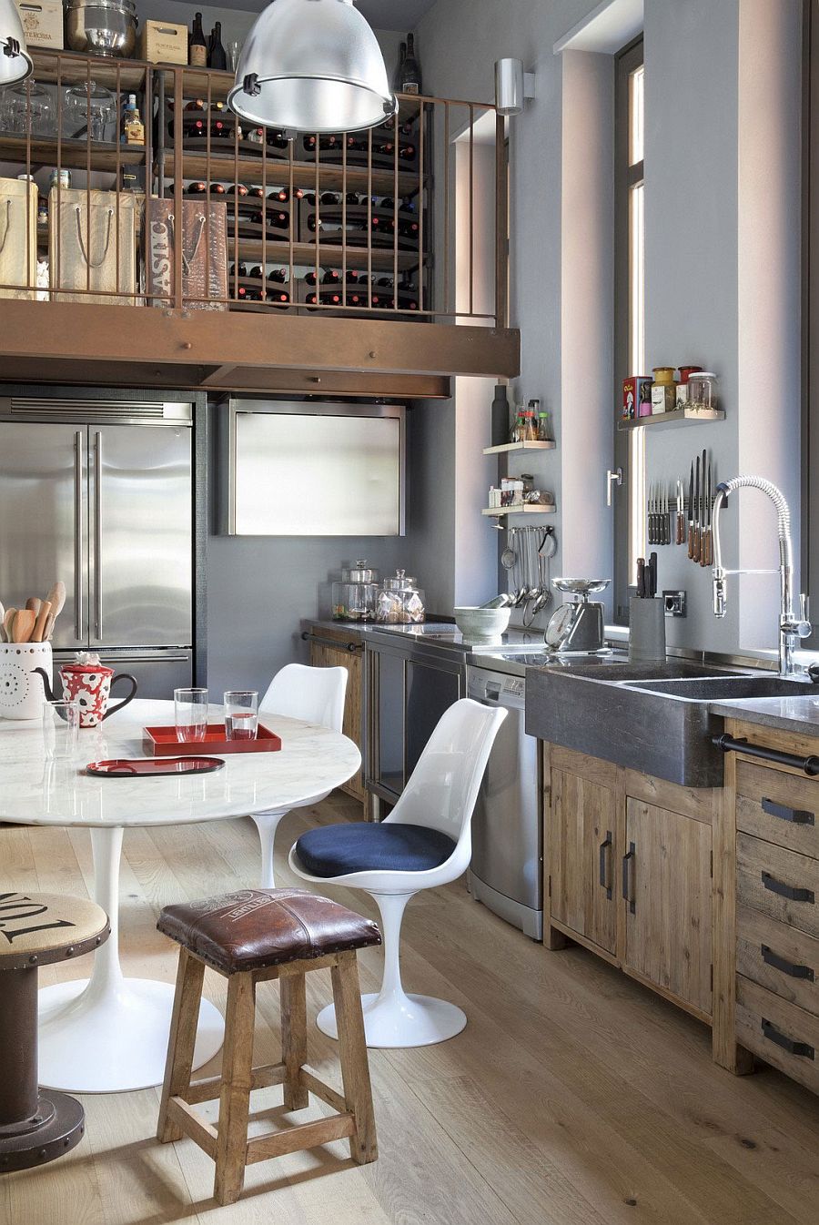 Stone sink and wooden cabinets along with the timeless Tulip chairs in the kitchen