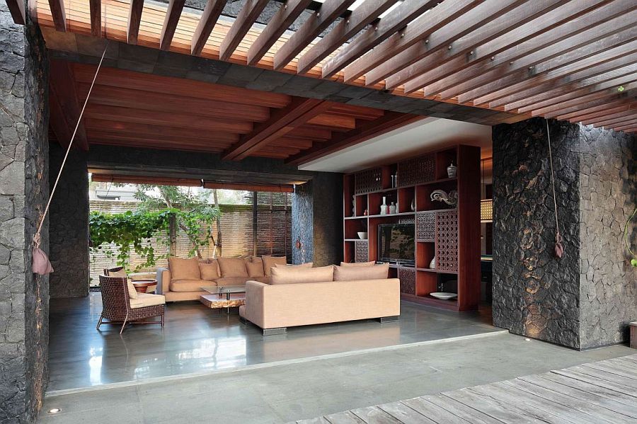 Stone walls shape the open living room of the Bali home