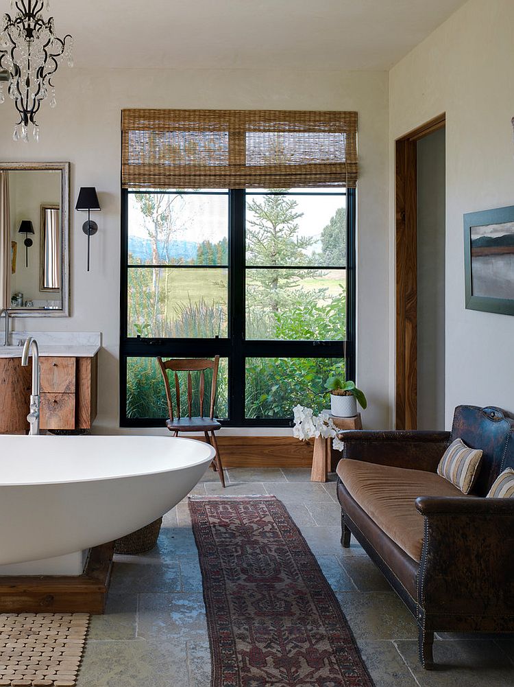 Subtle touches such as the wood pedestal for the bathtub usher in the rustic vibe [Design: Snake River Interiors]