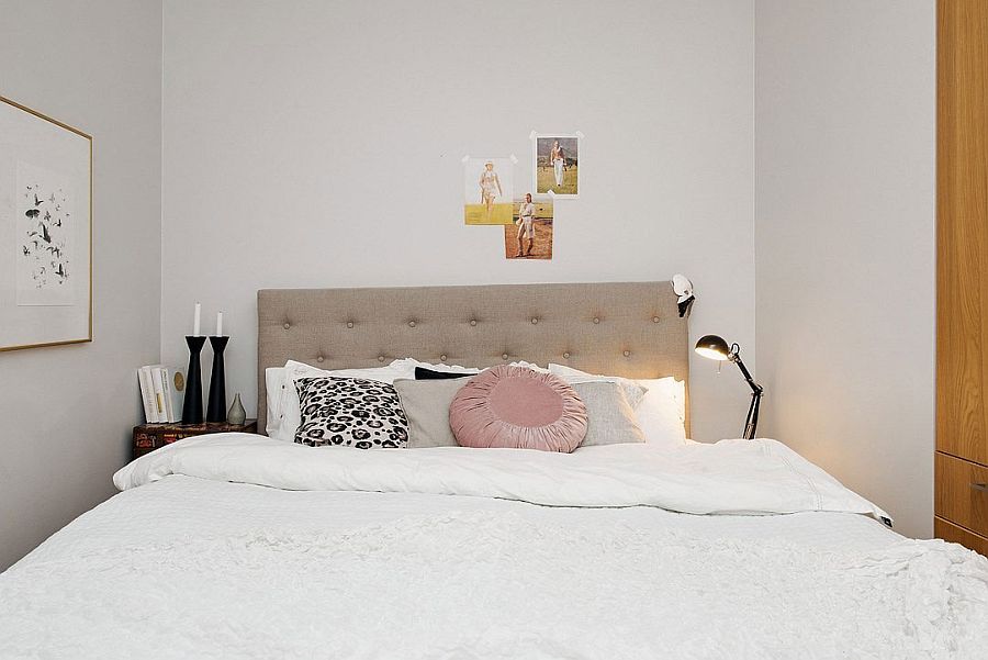 Tiny bedroom in white with small beside tables and floor lamp