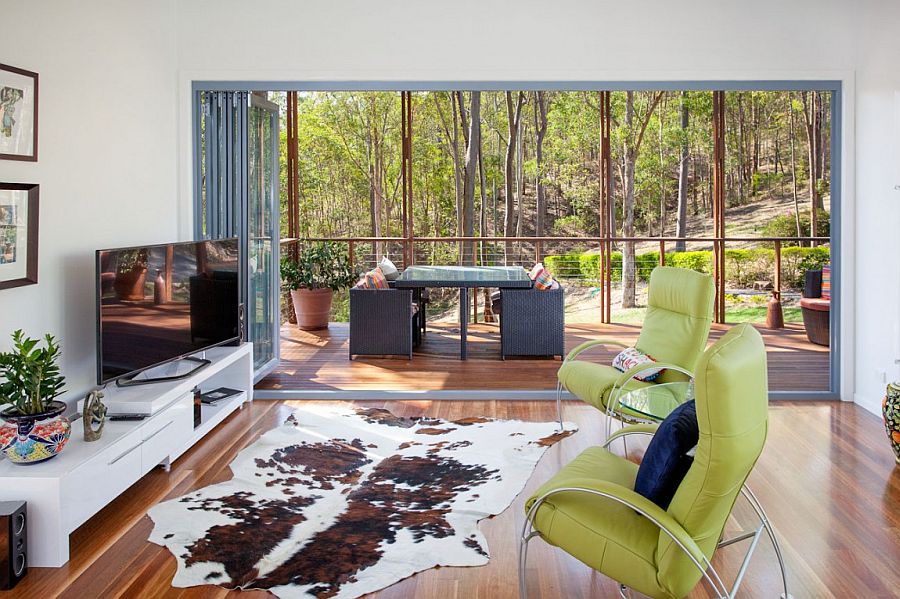 Twin chairs, cowhide rug and sleek TV stand in the breezy living room