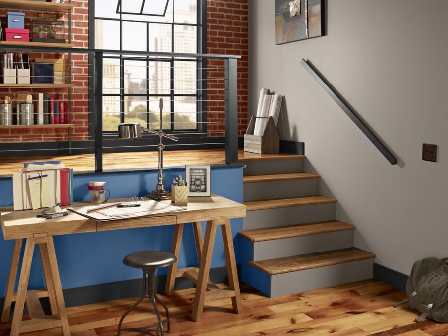 Wooden trestle desk in an industrial home office space