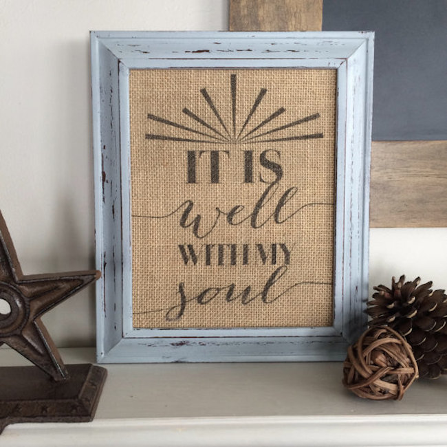 Framed burlap with quote displayed on furniture