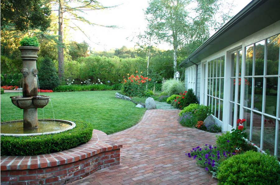 Brick patio beside a manicured lawn