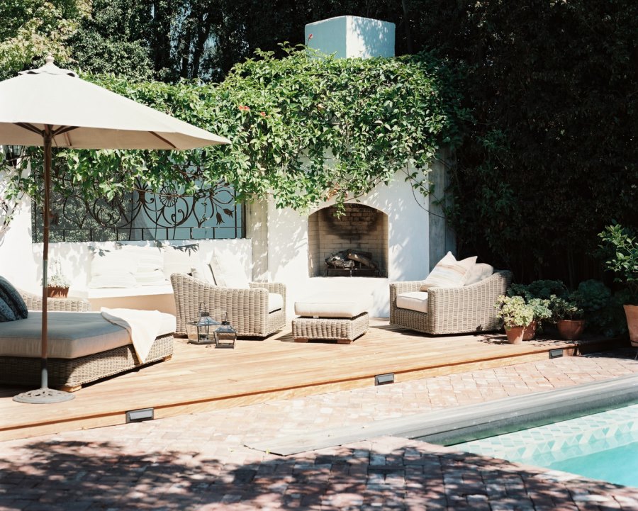 Brick patio beside a wooden deck