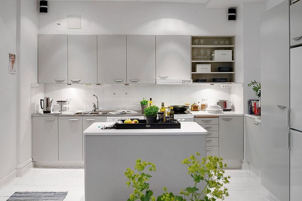 Clever lighting enhances the appeal of the chic Scandinavian kitchen design