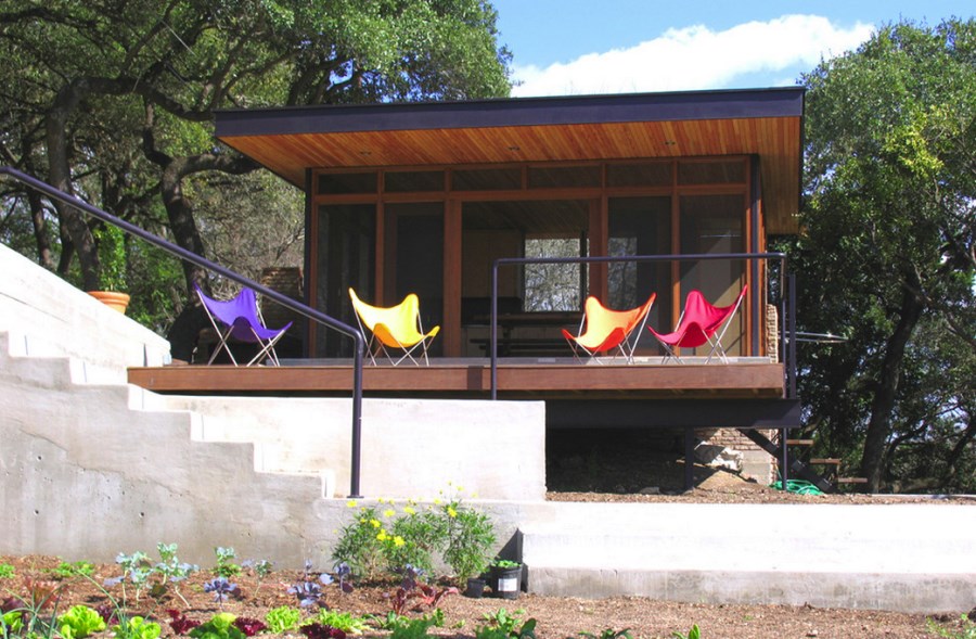 Colorful seating outside of a screened-in porch