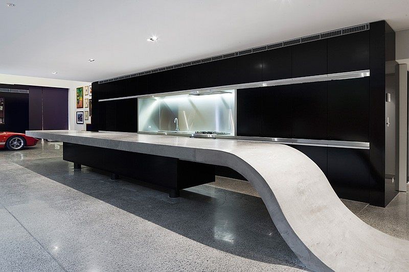 Custom concrete kitchen island with a black backdrop