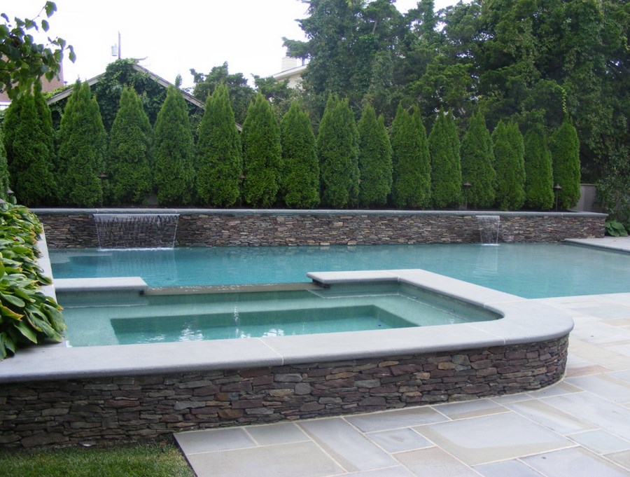 Cypress trees provide privacy to a pool area