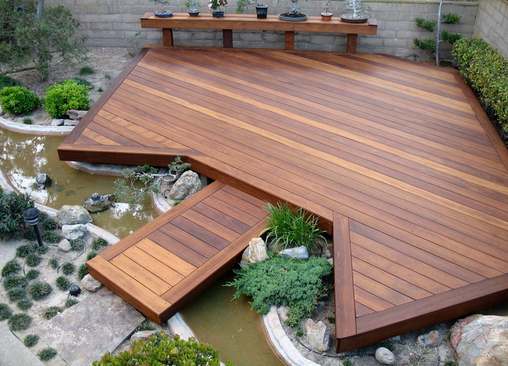 A floating deck over a stream makes a boring backyard beautiful