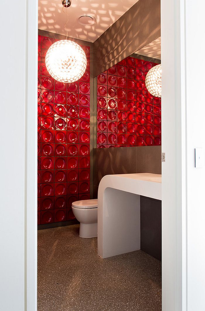 Gorgeous red tile steals the show in the small powder room