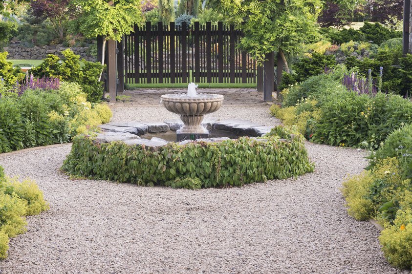 Graveled yard with a fountain focal point