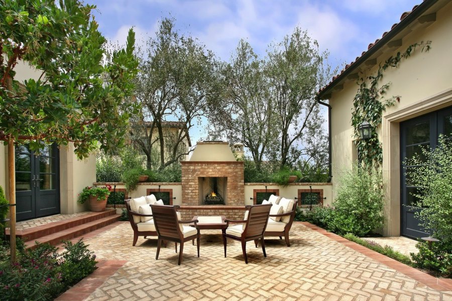 Herringbone patio near an outdoor fireplace