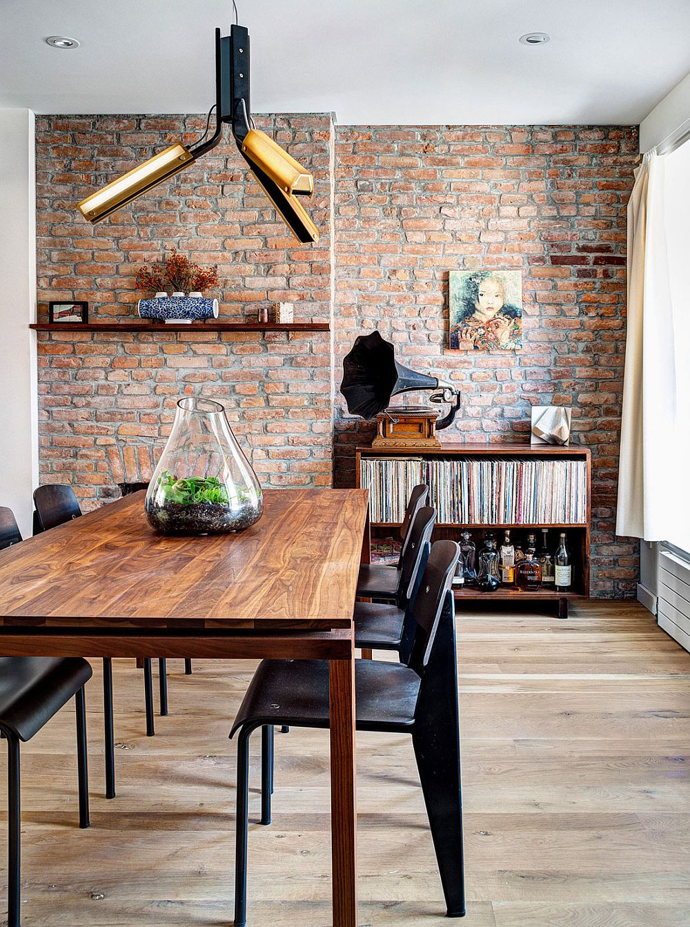 Industrial elements shape the renovated dining space with brick walls