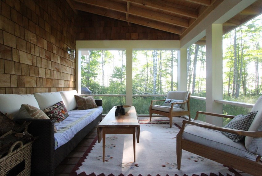 Living room setup in a screened-in porch