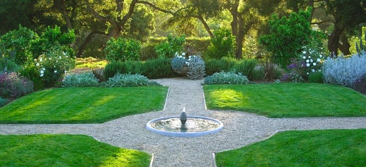 Lush green yard with a fountain at the center