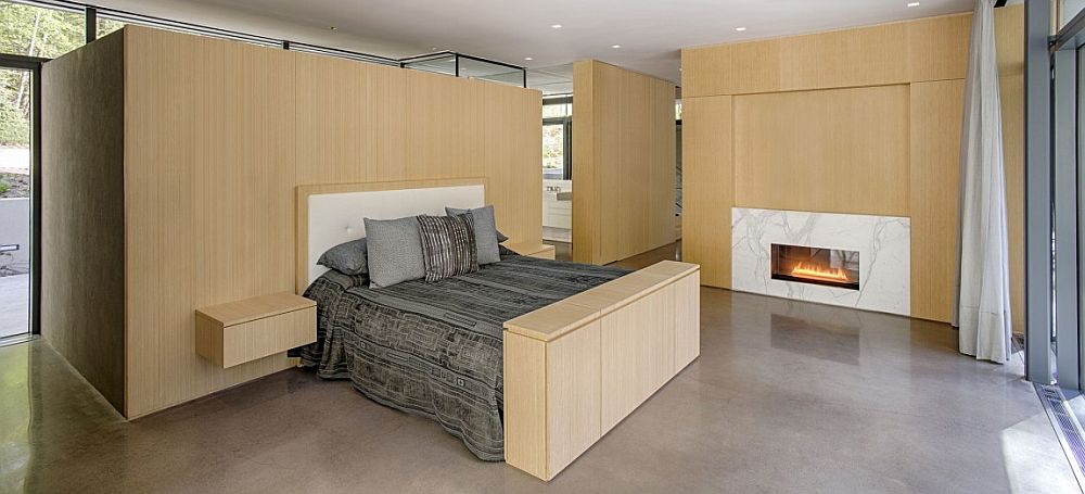 Minimal bedroom with marble fireplace and wooden walls