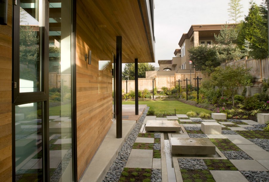 Modern yard with squares of concrete, gravel and plants