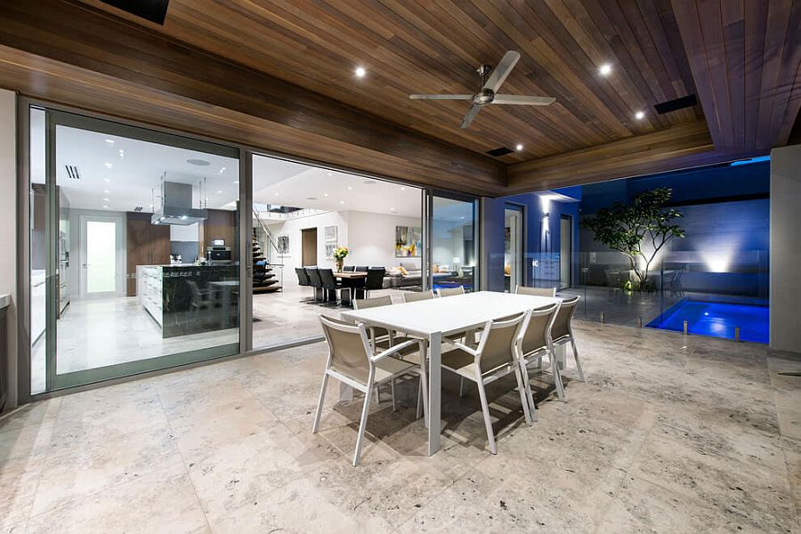 Outdoor dining area of the Perth home with a view of the pool