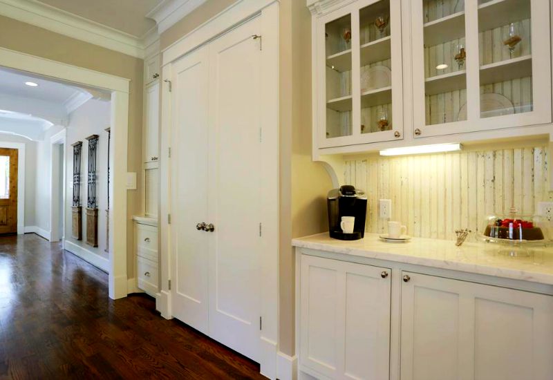 An all-white kitchen with reclaimed beadboard backdrop