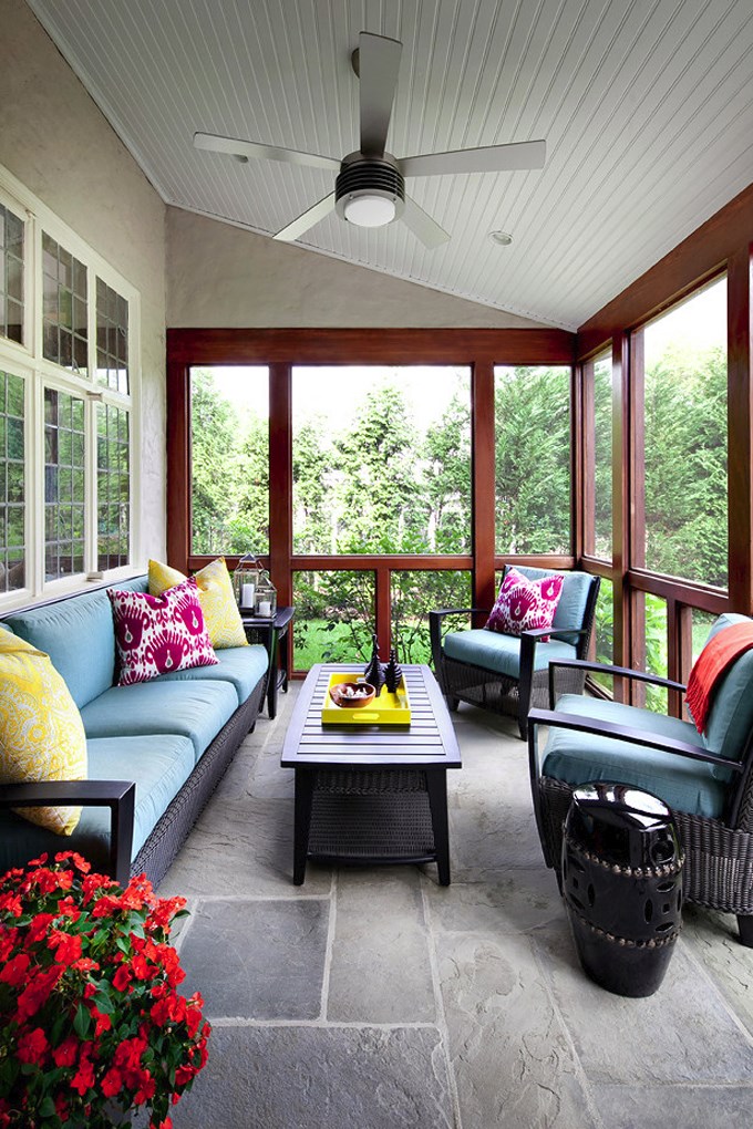 Screened-in porch with colorful throw pillows