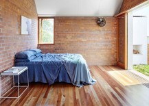 Sliding-glass-doors-connect-the-brick-wall-bedroom-to-the-backyard-217x155