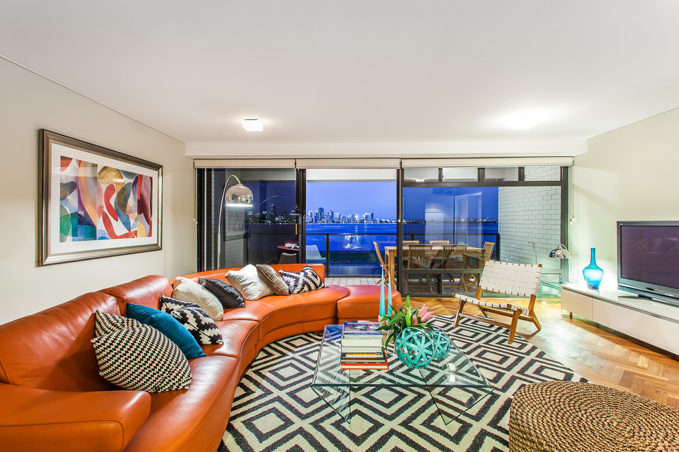 Stylish and cheerful living room with a splash of orange