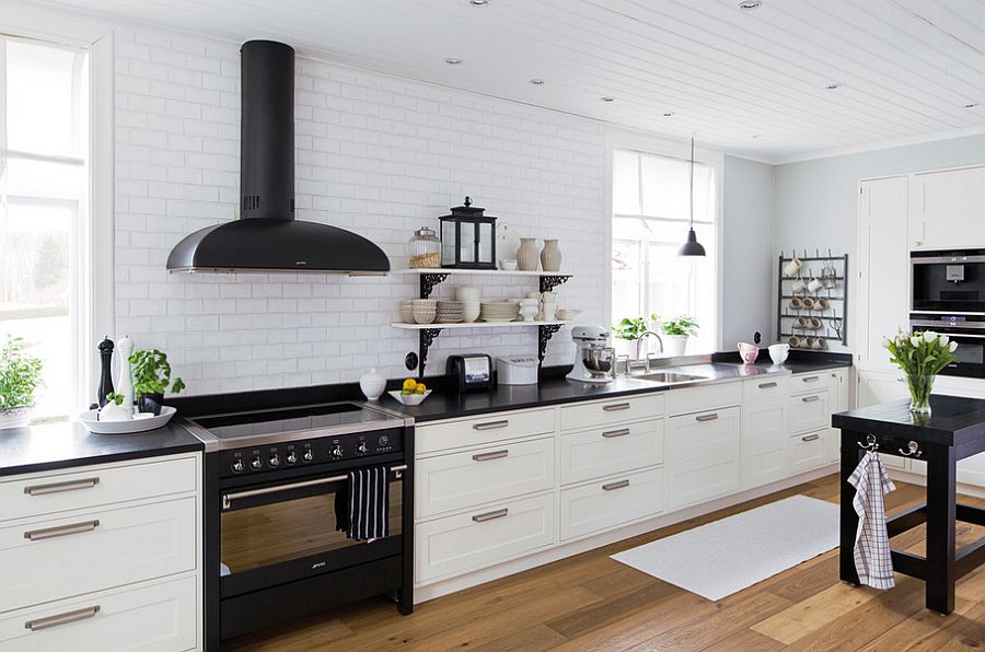 White backdrop of the kitchen lets the darker additions stand out visually [Design: Kungsäter Kök Göteborg]