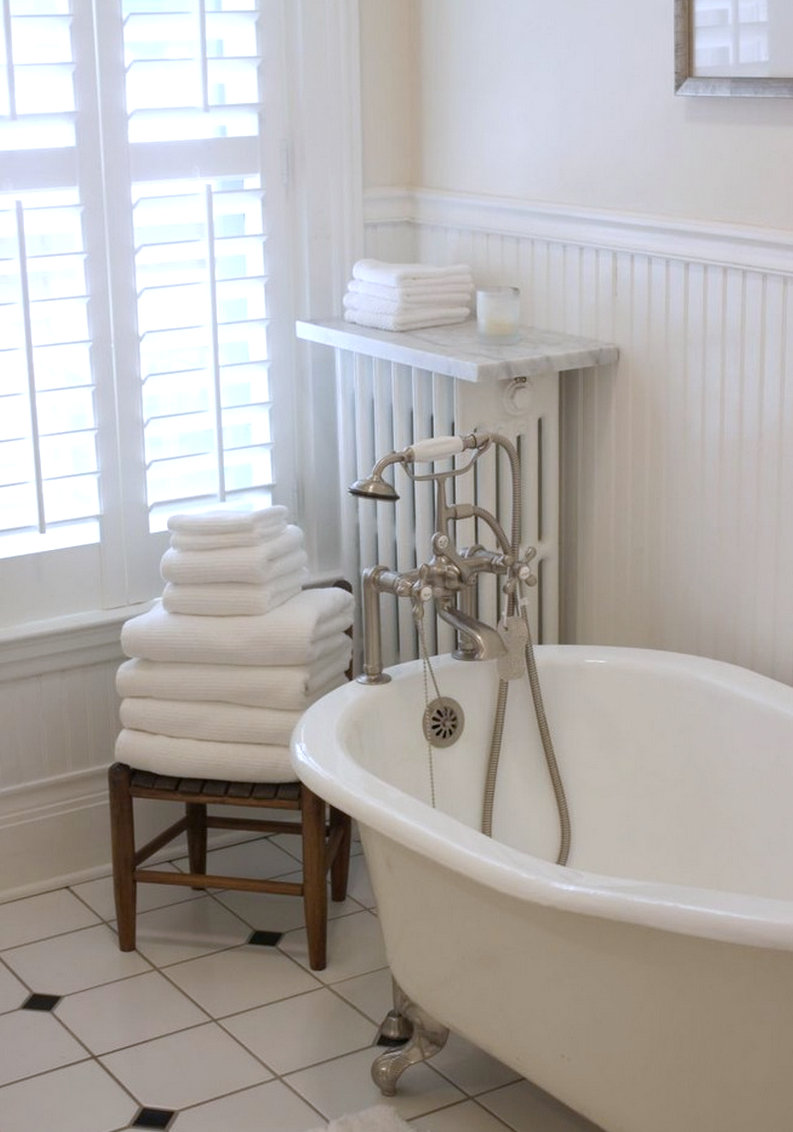 White bathroom with tile and beadboard paneling