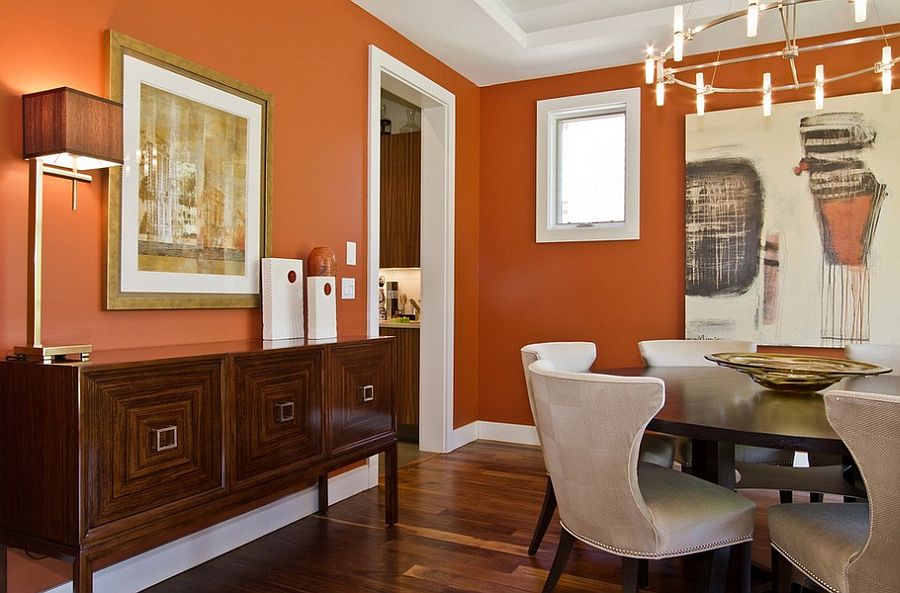 White trim brings elegance to the contemporary dining room in orange