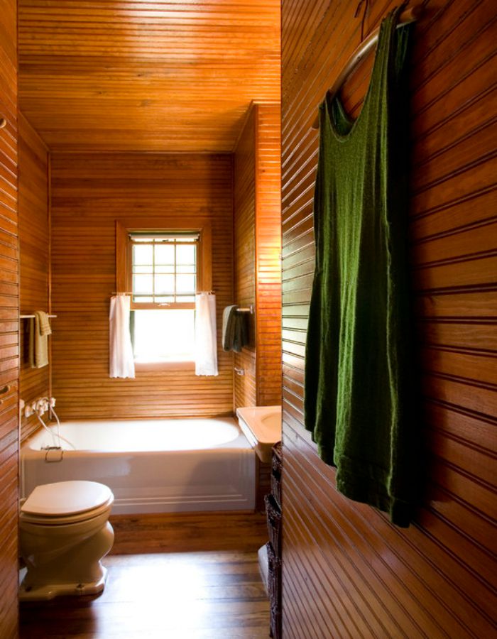 A warm and inviting wood-lined bathroom