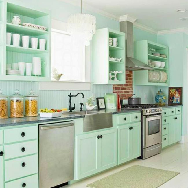 Kitchen with pale green beadboard and splashes of stainless steel