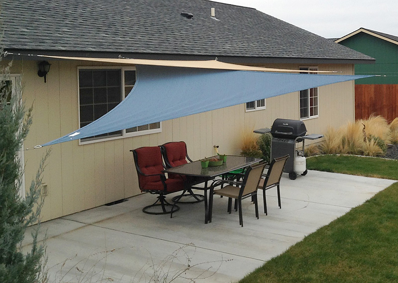 Shade sail above outdoor dining room