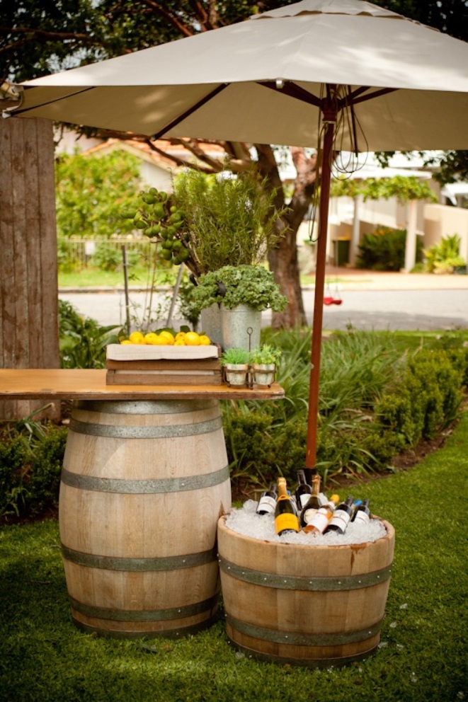 Relaxing outdoor lounge with wine barrels and umbrella